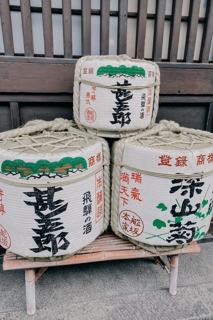 white sake barrels outside a brewery indicating that it's ready for one of the best things to do in takayama - sake tasting