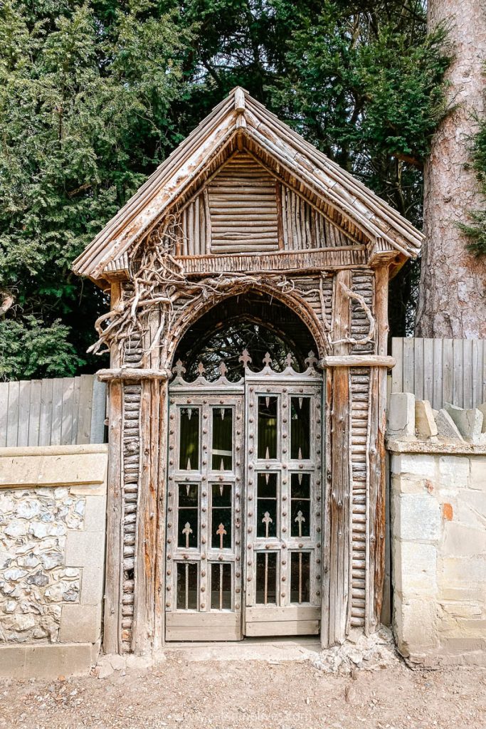 An old wooden gateway with carved patterns in Mickleham churchyard