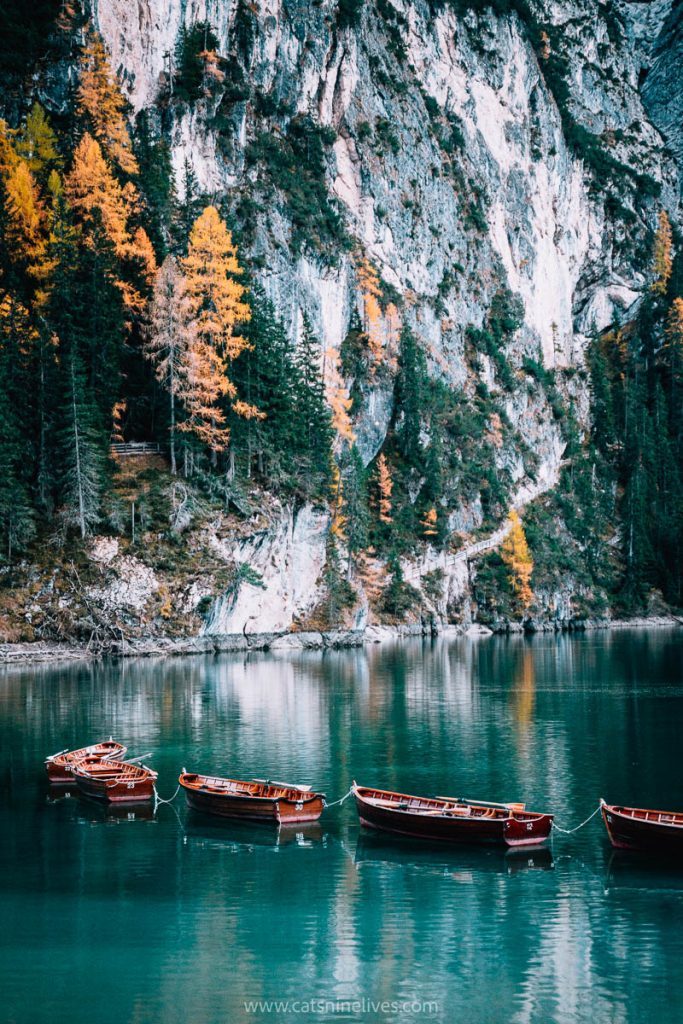 small wooden rowing boats moored on the water of lago di braies