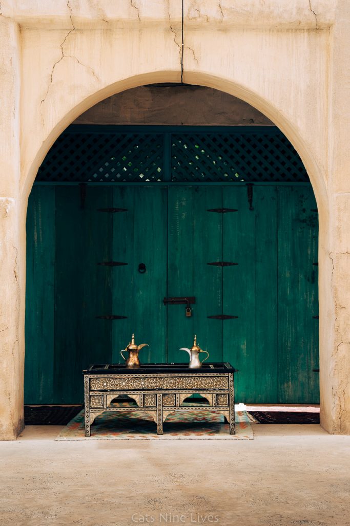 A coffee table with a turquoise door in Bur Dubai