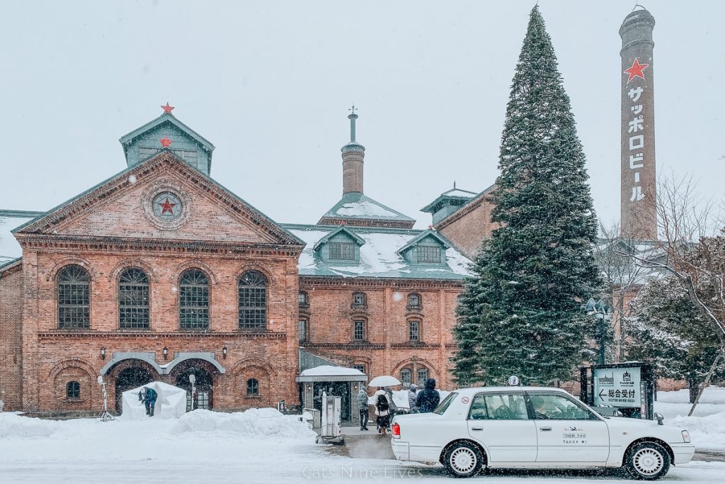 The Sapporo beer factory in Japan - a red brick building with green roof in the snow